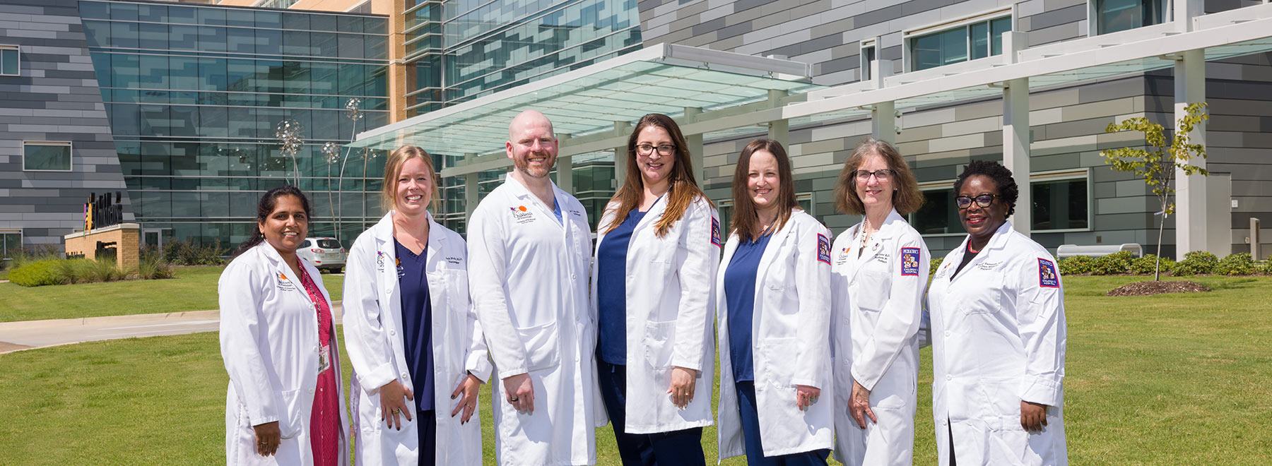 group picture of neonatal fellows standing outside of Sanderson Tower